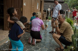 04/04/2013 - Siem Reap (Cambodia). A group of tourists from Norway take pictures and play with some of the kids who live in Acodo, one of the largest and most visited orphanage in Siem Reap. Playing with and hugging the children may make a tremendous impact on the tourists - and a great photo opportunity - but does little to support the needs of the children.  © Thomas Cristofoletti 2013
