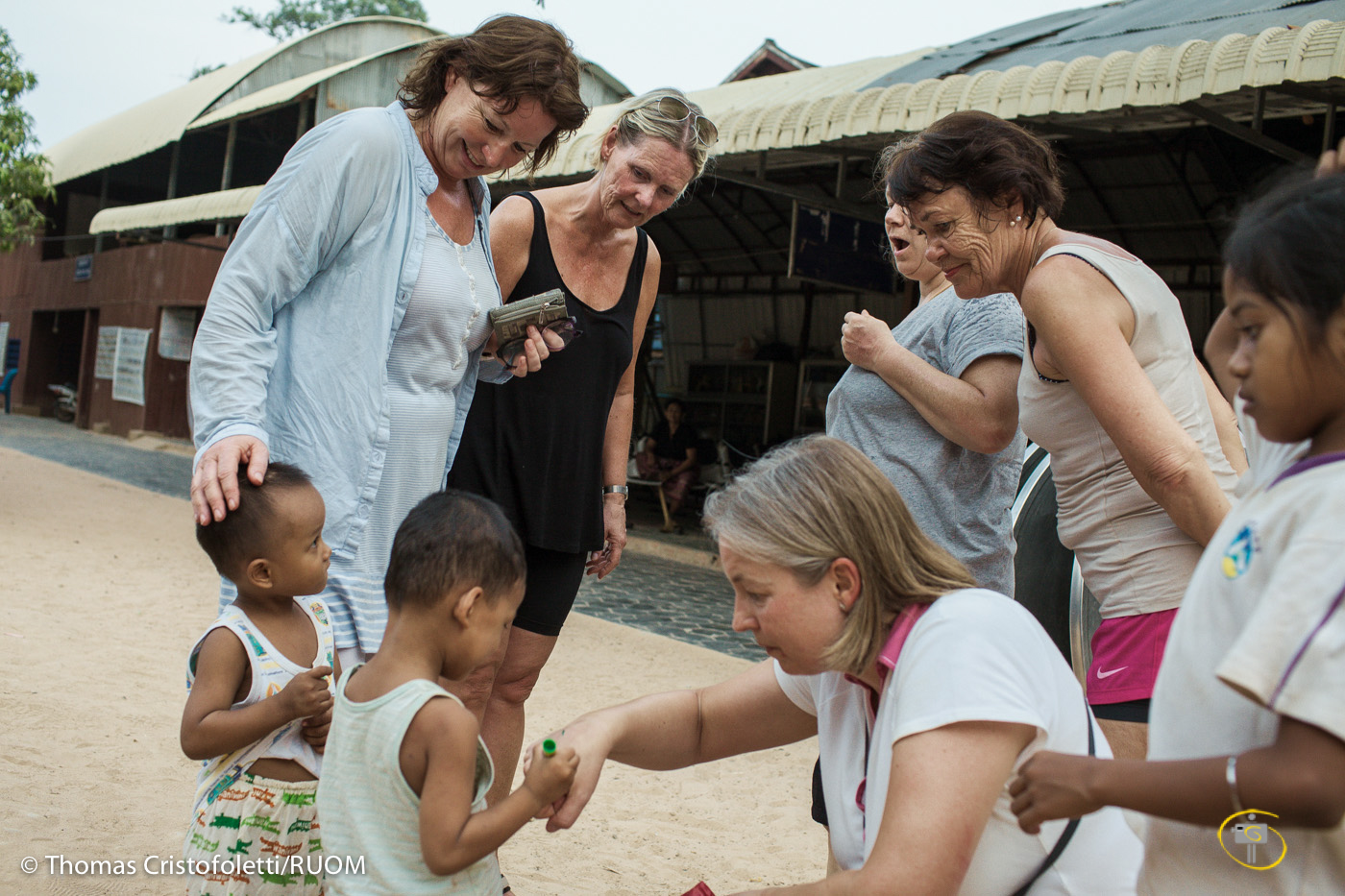 04/04/2013 - Siem Reap (Cambodia). A group of tourists from Norway visits Acodo, one of the largest and most visited orphanage in Siem Reap. Playing with and hugging the children may make a tremendous impact on the tourists - and a great photo opportunity - but does little to support the needs of the children. © Thomas Cristofoletti 2013